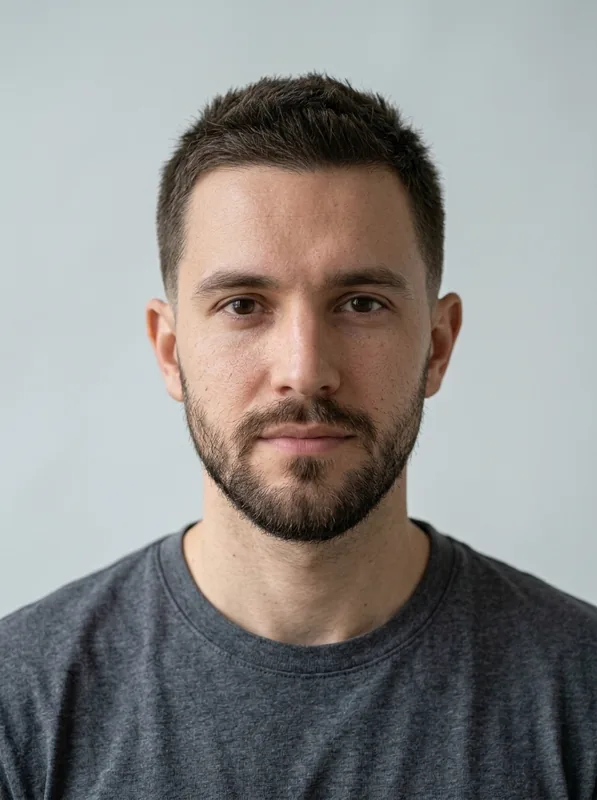 Crew Cut with Low Taper preview on the same fictional man with a beard in a charcoal shirt